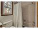 Bathtub and toilet in a well-lit bathroom with a window, combining practicality and comfort at 102 Eastover Cir, Summerville, SC 29483