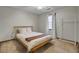 Cozy bedroom with a natural wood frame bed, plush carpet, and natural light from the window at 102 Eastover Cir, Summerville, SC 29483