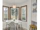 Bright breakfast nook features a white table, decorative light fixture, and large windows at 102 Eastover Cir, Summerville, SC 29483