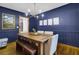 Elegant dining room with blue walls, wood floors, and a large rustic table at 102 Eastover Cir, Summerville, SC 29483
