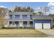 Charming two-story home featuring a welcoming front porch and a two-car garage at 102 Eastover Cir, Summerville, SC 29483