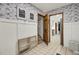 Hallway features tiled floors and walls lined with unique black and white illustrated wallpaper at 102 Eastover Cir, Summerville, SC 29483