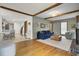 Open-concept living room with wood floors, brick fireplace, and seamless connection to the kitchen at 102 Eastover Cir, Summerville, SC 29483