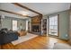 Inviting living room features a fireplace, wood floors, and bookshelves; perfect for relaxing at 102 Eastover Cir, Summerville, SC 29483