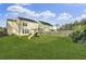 Wide backyard view with a wooden playground and trees at 1052 Whitlow Blvd, Summerville, SC 29483