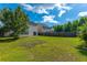Spacious backyard with a patio, bordered by a wooden fence and green trees at 1052 Whitlow Blvd, Summerville, SC 29483