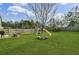 Picturesque backyard offering a large tree, playset and backyard patio at 1052 Whitlow Blvd, Summerville, SC 29483