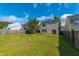 Expansive backyard with lush green grass, mature tree, and a classic wooden fence at 1052 Whitlow Blvd, Summerville, SC 29483
