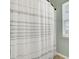 Shower and bath with shower curtain and small window for natural light at 1052 Whitlow Blvd, Summerville, SC 29483
