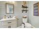 Charming bathroom features plank walls, stylish floating shelves, modern fixtures, and decorative accents at 1052 Whitlow Blvd, Summerville, SC 29483