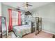 Fun bedroom with a unique wooden bunk bed and a large window covered with red curtains at 1052 Whitlow Blvd, Summerville, SC 29483