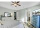 Bright main bedroom featuring a ceiling fan, dresser with ornate mirror, and an en-suite bathroom at 1052 Whitlow Blvd, Summerville, SC 29483