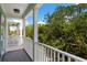 View from the home's balcony overlooking a mature tree canopy at 112 E Huron Ave # C, Folly Beach, SC 29439