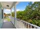Home's balcony with street and tree canopy views at 112 E Huron Ave # C, Folly Beach, SC 29439