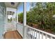 This balcony features wood flooring and white railings, providing an excellent view of the outdoors at 112 E Huron Ave # C, Folly Beach, SC 29439