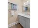 A bright bathroom showcasing a grey vanity with a white countertop and a modern framed mirror at 112 E Huron Ave # C, Folly Beach, SC 29439