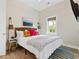 Bright bedroom showcasing decorative pillows, stylish hanging lamps, and a modern ceiling fan at 112 E Huron Ave # C, Folly Beach, SC 29439