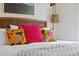 Comfortable bedroom decor features textured headboard, bright decorative pillows, and a stylish hanging lamp at 112 E Huron Ave # C, Folly Beach, SC 29439