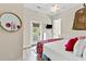 Bright bedroom featuring walk out balcony, TV, and white dresser at 112 E Huron Ave # C, Folly Beach, SC 29439
