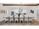 Bright dining room features a wooden table with seating for twelve and a view into the modern kitchen at 112 E Huron Ave # C, Folly Beach, SC 29439