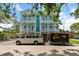 A two-story home showcases a beautiful exterior with double porches and ample parking space at 112 E Huron Ave # C, Folly Beach, SC 29439
