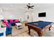 Bright game room with a dark blue sofa, and a felt top pool table ready for play at 112 E Huron Ave # C, Folly Beach, SC 29439