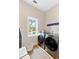 Well-lit laundry room featuring a modern washer and dryer and a bright window at 112 E Huron Ave # C, Folly Beach, SC 29439