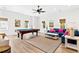 Spacious living room with a pool table, blue sofa with colorful pillows, and neutral-toned decor at 112 E Huron Ave # C, Folly Beach, SC 29439