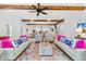 Spacious open-concept living area featuring hardwood floors, stylish furniture, and exposed wood beams at 112 E Huron Ave # C, Folly Beach, SC 29439