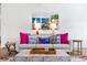 Bright living room featuring modern decor, stylish furniture, and vibrant coastal-themed artwork at 112 E Huron Ave # C, Folly Beach, SC 29439