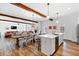 Open floor plan with combined living, dining, and kitchen areas, enhanced by rustic wood beam accents at 112 E Huron Ave # C, Folly Beach, SC 29439