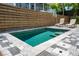 Relaxing pool area featuring lounge chairs, an umbrella and a privacy fence for ultimate enjoyment at 112 E Huron Ave # C, Folly Beach, SC 29439