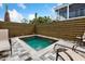 Take a dip in this pool surrounded by lounge chairs and a modern wooden fence for added privacy at 112 E Huron Ave # C, Folly Beach, SC 29439