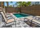 Inviting pool with lounge chairs and a privacy fence, perfect for relaxation and summer fun at 112 E Huron Ave # C, Folly Beach, SC 29439
