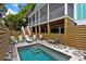 Enjoy the backyard pool, complete with a paved patio and wooden privacy fence at 112 E Huron Ave # C, Folly Beach, SC 29439