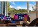 Relax on this porch featuring wicker furniture, blue cushions, and a beautiful wooded view at 112 E Huron Ave # C, Folly Beach, SC 29439