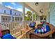 Relax on this spacious porch with wicker furniture and a stunning view of the neighborhood and palm trees at 112 E Huron Ave # C, Folly Beach, SC 29439