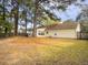 Spacious backyard with lawn, trees, and exterior view of the house at 115 St Awdry St, Summerville, SC 29485