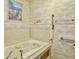 Bathroom showcasing a jacuzzi-style tub, decorative wallpaper, and accessibility grab bars at 115 St Awdry St, Summerville, SC 29485
