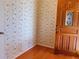 Entryway featuring decorative wallpaper, hardwood flooring, and wooden door with glass insert at 115 St Awdry St, Summerville, SC 29485
