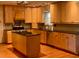 Spacious kitchen featuring wooden cabinets, black countertops, and a convenient center island at 115 St Awdry St, Summerville, SC 29485