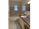 Functional bathroom featuring neutral tile, a bath tub with safety rails, and a practical sink and vanity at 125 Azalea Dr, Summerville, SC 29485