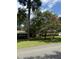 Well-manicured front yard featuring lush green grass and a variety of beautiful trees and flowering plants at 125 Azalea Dr, Summerville, SC 29485
