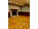 Inviting living room features a classic brick fireplace and gleaming hardwood floors at 125 Azalea Dr, Summerville, SC 29485