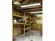 Shed interior featuring bright lighting, workbench with open shelves and pegboard for storage at 125 Azalea Dr, Summerville, SC 29485