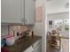 Bright kitchen featuring grey countertops, backsplash, and a view to a brightly-lit adjacent office at 150 Rockingham Way, Moncks Corner, SC 29461