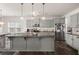 Spacious kitchen with grey cabinets, a large granite island, and stainless steel appliances at 150 Rockingham Way, Moncks Corner, SC 29461