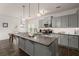 Bright kitchen featuring a large island, grey cabinets, stainless appliances and an adjacent dining area at 150 Rockingham Way, Moncks Corner, SC 29461