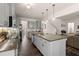 Open concept kitchen features a spacious island, white cabinets, and transitions into a cozy living area at 150 Rockingham Way, Moncks Corner, SC 29461