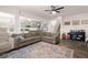 Open-concept living room featuring a large sofa, view of kitchen and dining, and natural light at 150 Rockingham Way, Moncks Corner, SC 29461